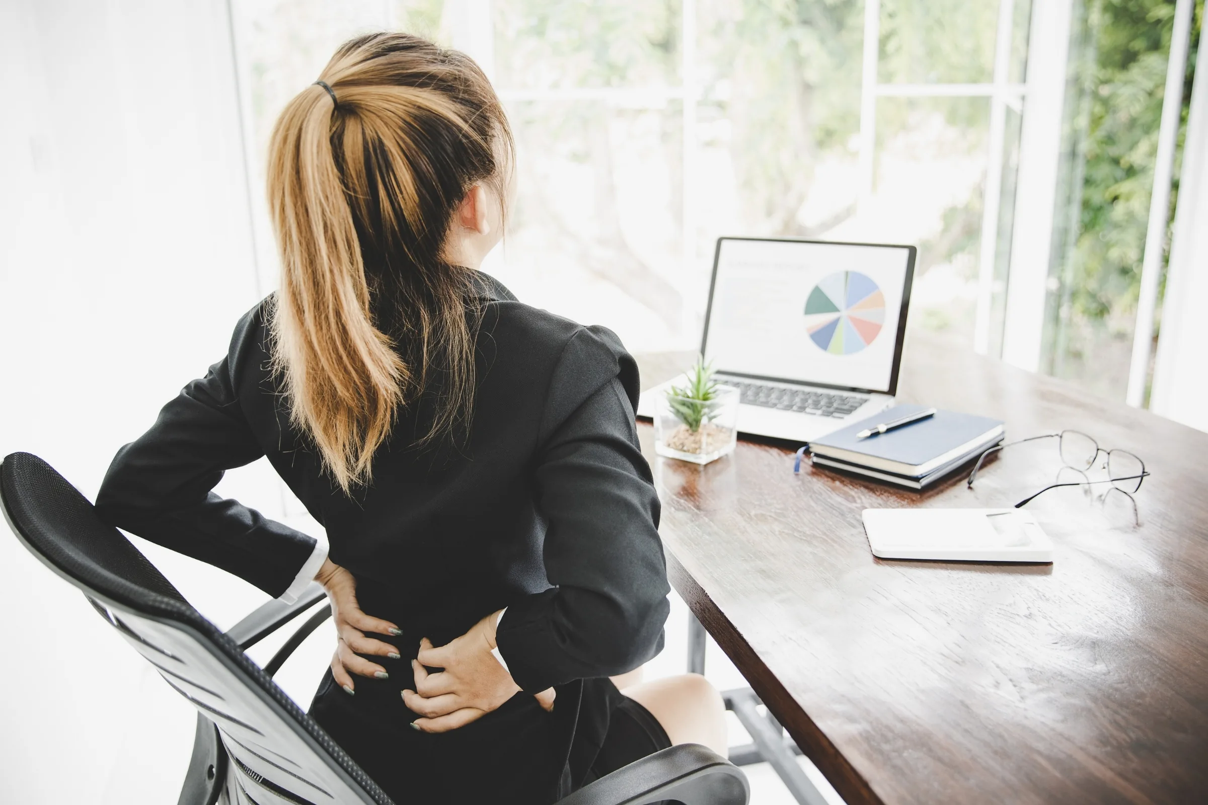 Low back pain at a desk, the posture it most often builds in
