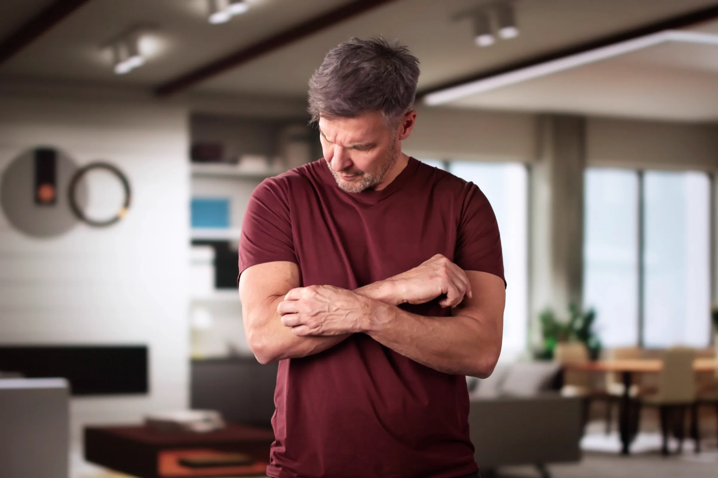 Holding a forearm where radiating pain and tingling are felt